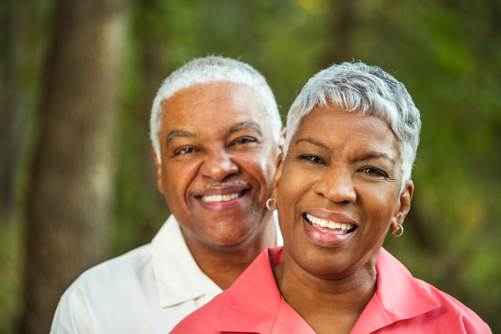 man and woman smiling.
